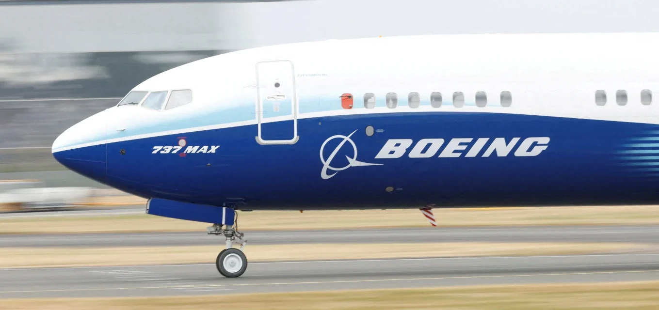 Boeing 737 MAX aircraft taxiing on a runway ahead of aerospace technology showcase at Farnborough Expo.