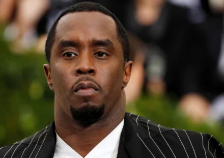 Sean Combs in a black pinstripe suit at a public event before reported prison altercation developments.