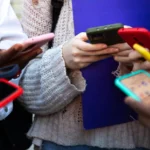 Children using smartphones at school as Europe considers stricter social media age limits for minors.