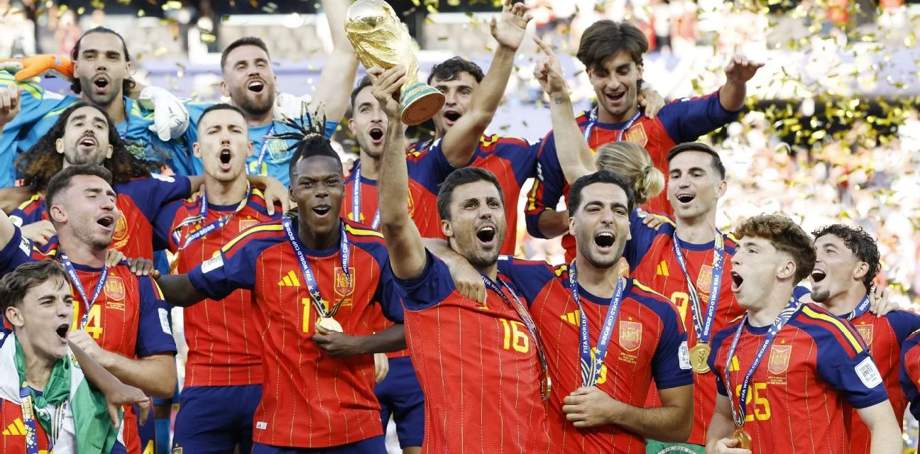 Spain players celebrate with the FIFA World Cup trophy as golden confetti falls after the final victory.