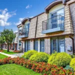 Modern multi family apartment community with landscaped gardens, balconies, and walkways in a Mid Atlantic neighborhood.