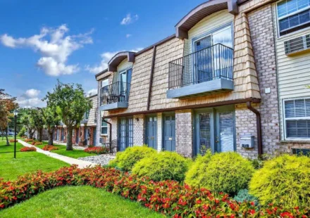 Modern multi family apartment community with landscaped gardens, balconies, and walkways in a Mid Atlantic neighborhood.