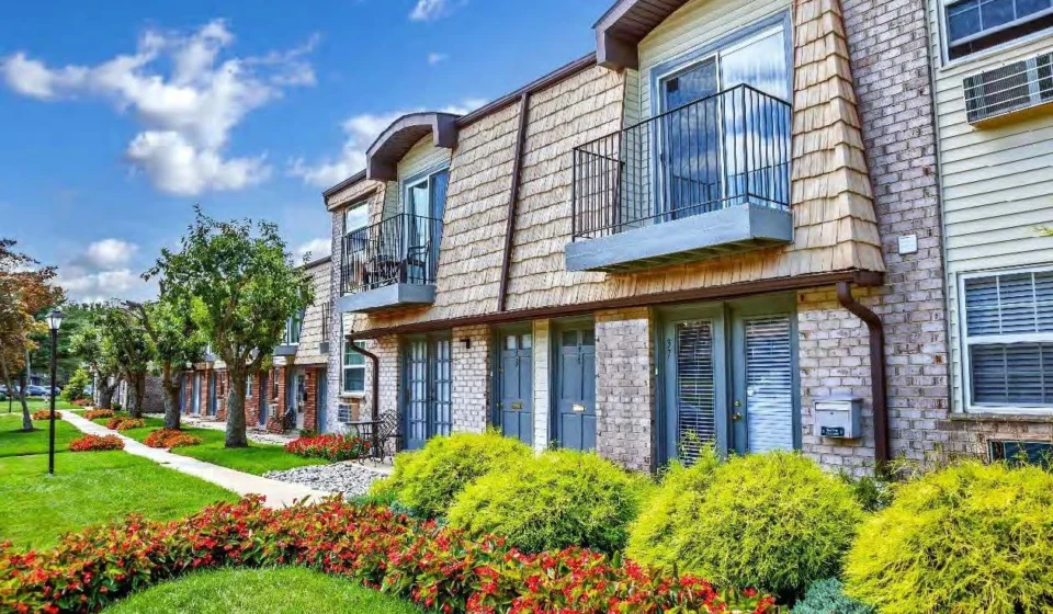 Modern multi family apartment community with landscaped gardens, balconies, and walkways in a Mid Atlantic neighborhood.