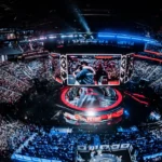 Packed esports arena with giant screens as fans watch an international gaming championship live.