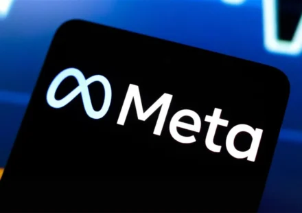 Meta logo displayed on a smartphone screen with a financial market chart, symbolizing AI investment growth.