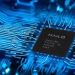 Hailo edge AI processor chip displayed on a blue circuit board representing advanced embedded AI technology.