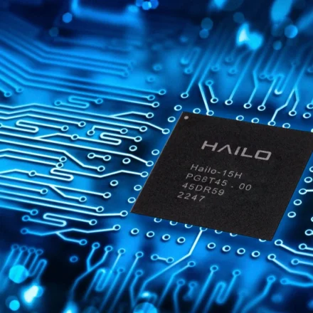 Hailo edge AI processor chip displayed on a blue circuit board representing advanced embedded AI technology.