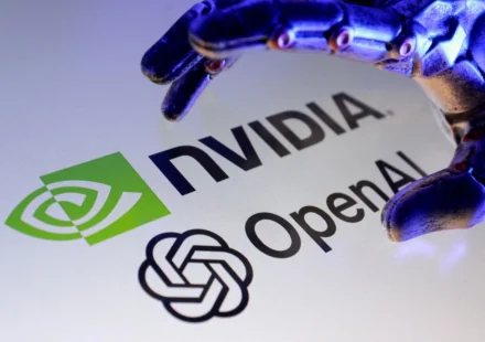 Nvidia and OpenAI logos beneath a robotic hand, symbolizing AI infrastructure investment and growth.