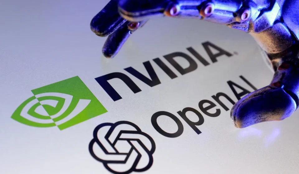 Nvidia and OpenAI logos beneath a robotic hand, symbolizing AI infrastructure investment and growth.