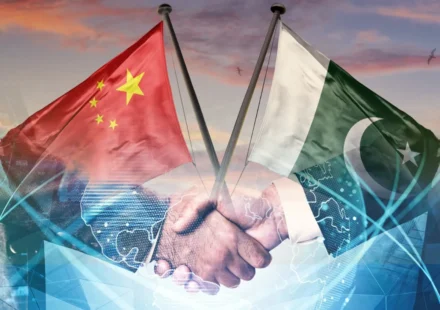 Pakistan and China flags over handshake symbolizing AI alliance and digital cooperation under CPEC 2.0 plan.