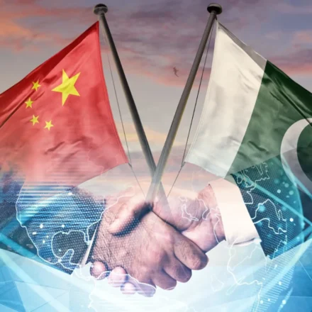 Pakistan and China flags over handshake symbolizing AI alliance and digital cooperation under CPEC 2.0 plan.