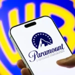 Paramount logo displayed on a smartphone as Warner Bros. merger faces legal review and delay.