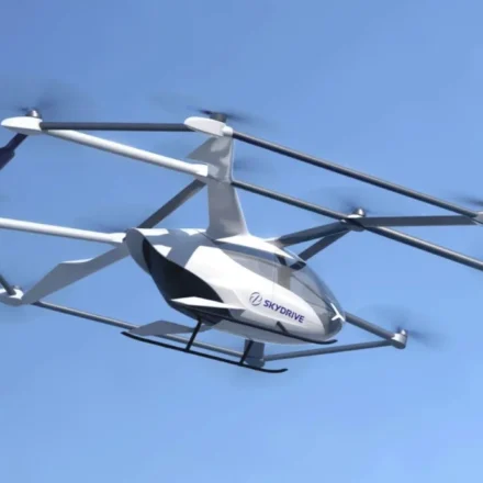 SkyDrive eVTOL aircraft flying in clear blue sky for future emergency medical transport services offshore.