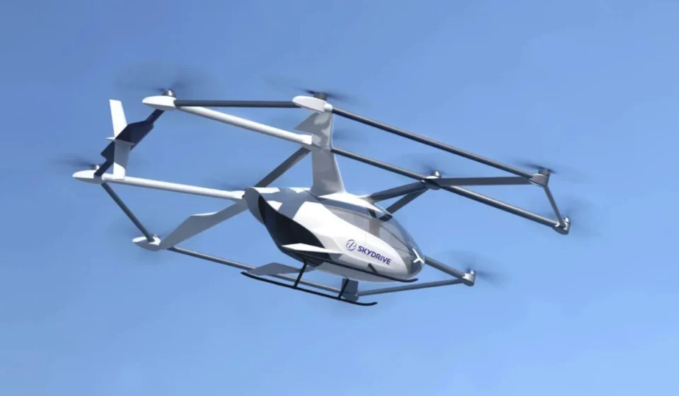 SkyDrive eVTOL aircraft flying in clear blue sky for future emergency medical transport services offshore.