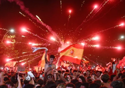 Crowds wave Spanish flags beneath fireworks as Madrid celebrates world title victory together. joy!!