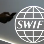 Swift logo displayed during announcement of global blockchain trial with major international banks initiative