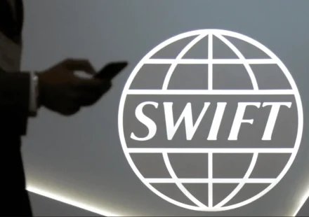 Swift logo displayed during announcement of global blockchain trial with major international banks initiative