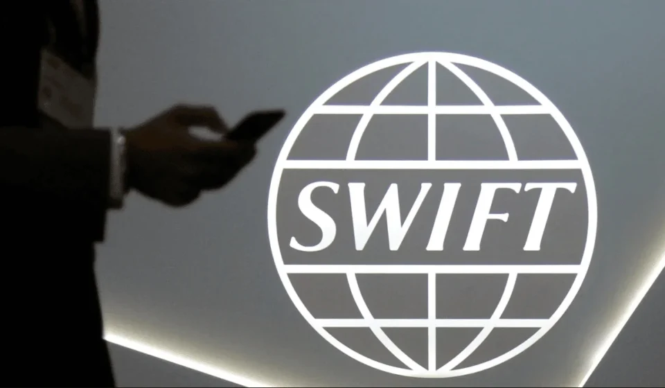 Swift logo displayed during announcement of global blockchain trial with major international banks initiative