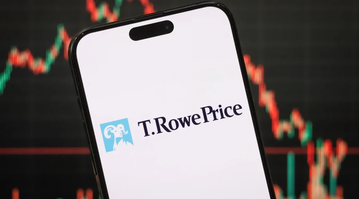 Smartphone displaying T. Rowe Price logo with cryptocurrency market chart blurred behind on screen.