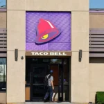 Taco Bell restaurant entrance with signature bell logo as FDA investigates lettuce linked Cyclospora outbreak.