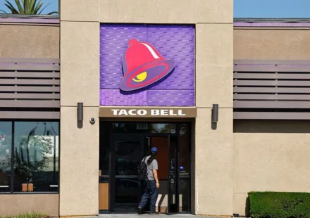 Taco Bell restaurant entrance with signature bell logo as FDA investigates lettuce linked Cyclospora outbreak.