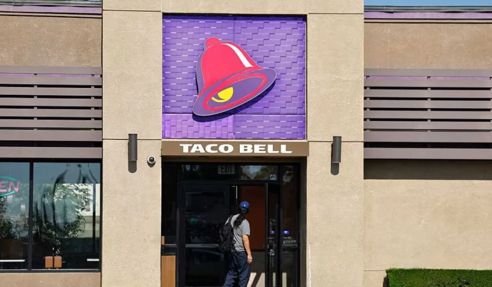 Taco Bell restaurant entrance with signature bell logo as FDA investigates lettuce linked Cyclospora outbreak.