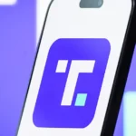 Smartphone displaying Trump Media app logo on purple background illustrating premium social platform
