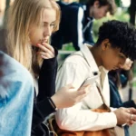 Teenagers using smartphones outdoors as UK proposes voluntary overnight social media curfew at night