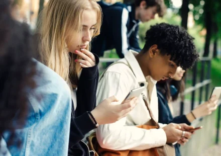Teenagers using smartphones outdoors as UK proposes voluntary overnight social media curfew at night