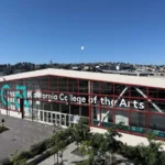 California College of the Arts campus building in San Francisco with modern glass facade under clear blue sky.