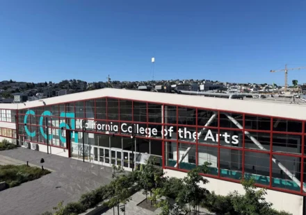California College of the Arts campus building in San Francisco with modern glass facade under clear blue sky.