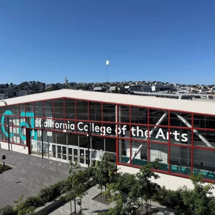 California College of the Arts campus building in San Francisco with modern glass facade under clear blue sky.