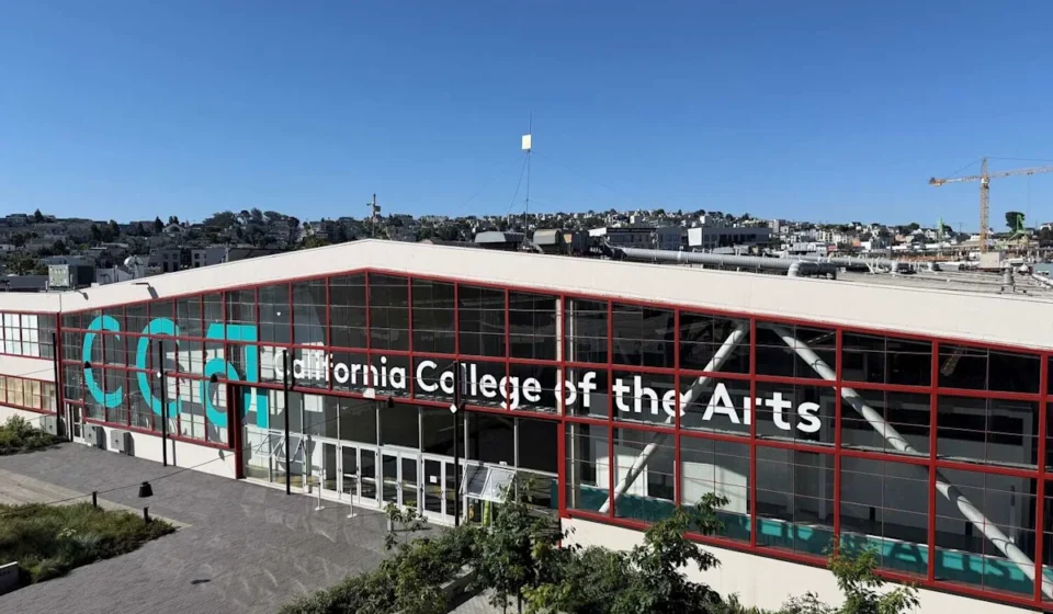 California College of the Arts campus building in San Francisco with modern glass facade under clear blue sky.