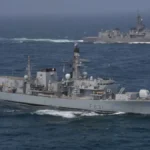 Two naval frigates patrol open waters during Red Sea maritime security coalition operations
