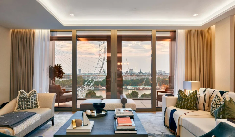 Architects Highlight Energy-Efficient Layered Lighting Standards Modern living room with layered lighting, floor to ceiling windows and natural daylight inside.