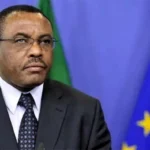 Hailemariam Dessalegn Boshe speaks before Ethiopian and European Union flags during an official address.