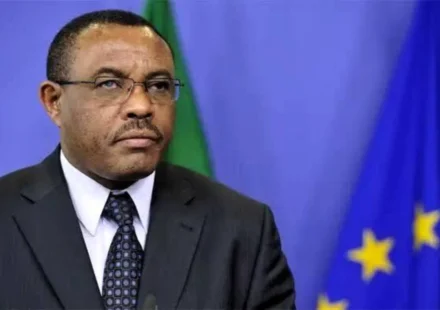 Hailemariam Dessalegn Boshe speaks before Ethiopian and European Union flags during an official address.