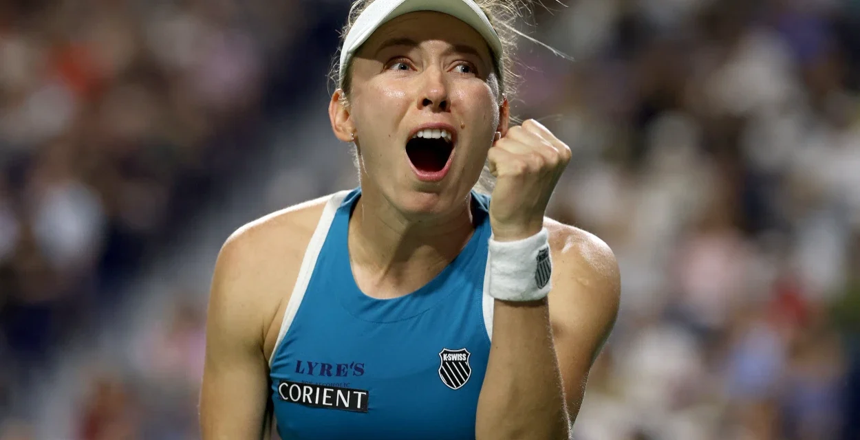 Tennis player celebrates with a raised fist and open mouth after a dramatic win on the Toronto court