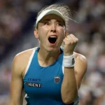 Tennis player celebrates with a raised fist and open mouth after a dramatic win on the Toronto court