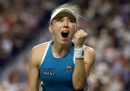 Tennis player celebrates with a raised fist and open mouth after a dramatic win on the Toronto court