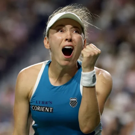 Tennis player celebrates with a raised fist and open mouth after a dramatic win on the Toronto court