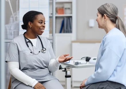 Healthcare provider discusses perimenopause symptoms with patient during a clinic consultation. care