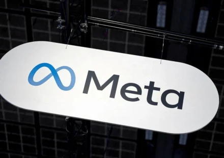Meta company logo displayed on a suspended sign during a technology event inside an exhibition hall.