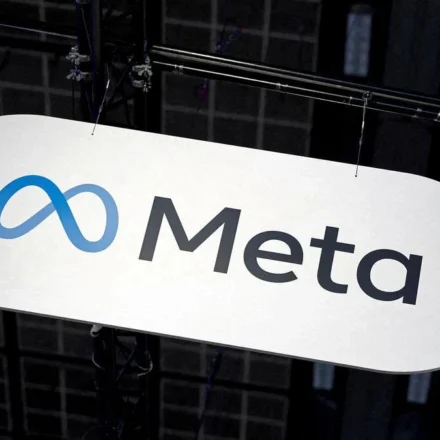Meta company logo displayed on a suspended sign during a technology event inside an exhibition hall.