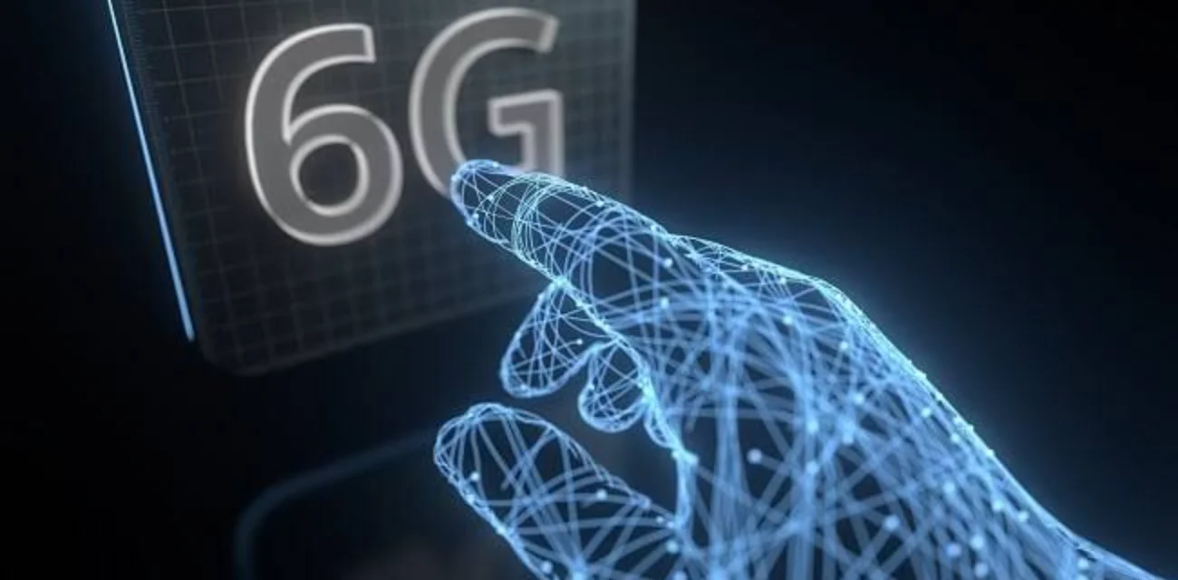 Futuristic AI hand reaching toward a glowing 6G display, representing future 6G mobile network tech.