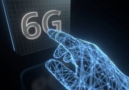 Futuristic AI hand reaching toward a glowing 6G display, representing future 6G mobile network tech.