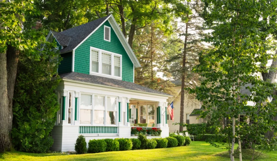 Pinterest and Zillow Partner on Smart DIY and Renovation Advertising Green and white cottage home with wraparound porch, shaded by trees