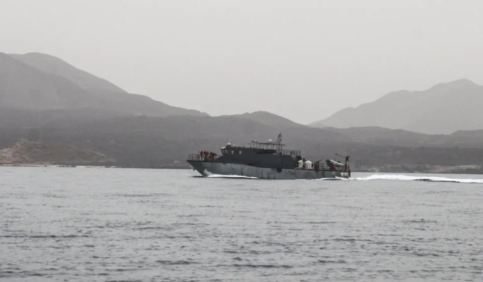 Red Sea Maritime Coalition Announced to Protect Commercial Shipping Naval patrol vessel speeds across calm Red Sea waters with rugged mountains in the distant background
