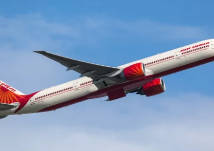 Air India passenger aircraft climbing into clear skies during an international flight to Delhi route.