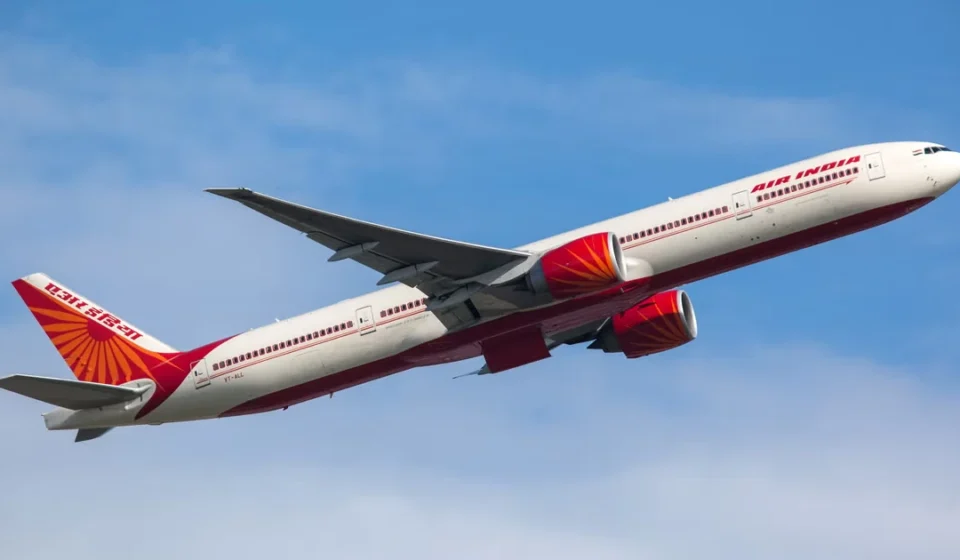 Air India passenger aircraft climbing into clear skies during an international flight to Delhi route.